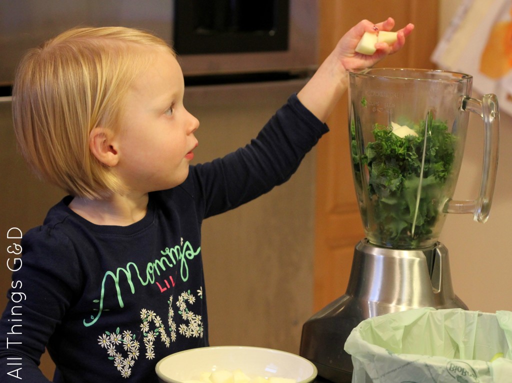 Kate, my little helper, adding ingredients to the blender.