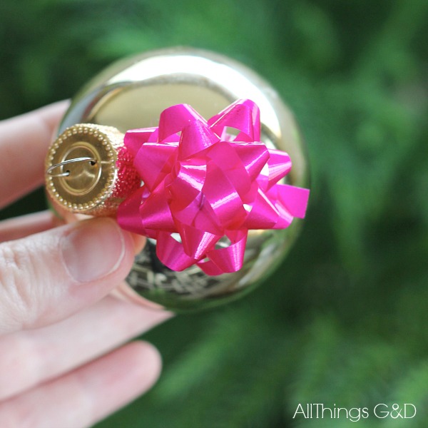 This DIY mini gift bow ornament is the easiest thing you'll make this holiday season.  Enjoy it on your tree or tape to a present for added (and reusable!) flair! | www.allthingsgd.com
