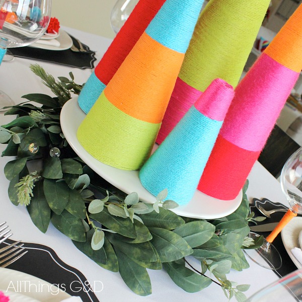 Bring color and whimsy to your holiday table with this colorful Christmas tablescape decorated with chalkboards and yarn! | www.allthingsgd.com